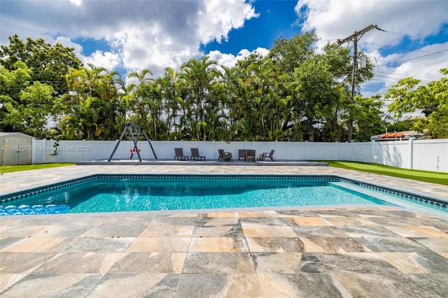 view of pool with a fenced backyard, a fenced in pool, and a patio