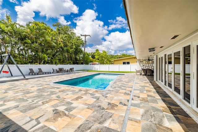 view of swimming pool with a fenced backyard, a fenced in pool, and a patio