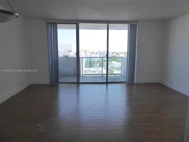 spare room with dark wood-type flooring