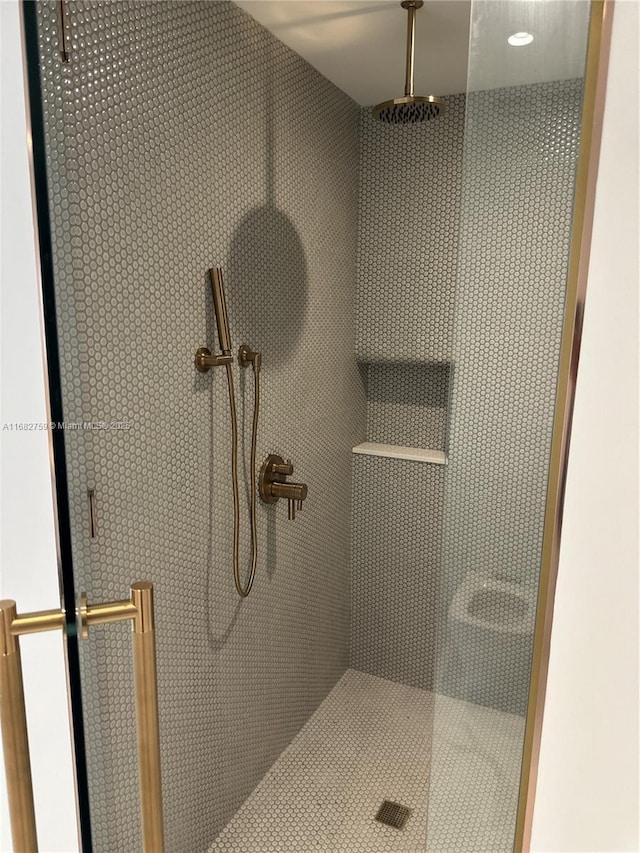 bathroom featuring a shower with door