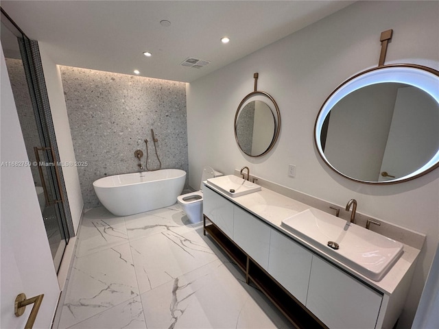 bathroom with vanity and a washtub