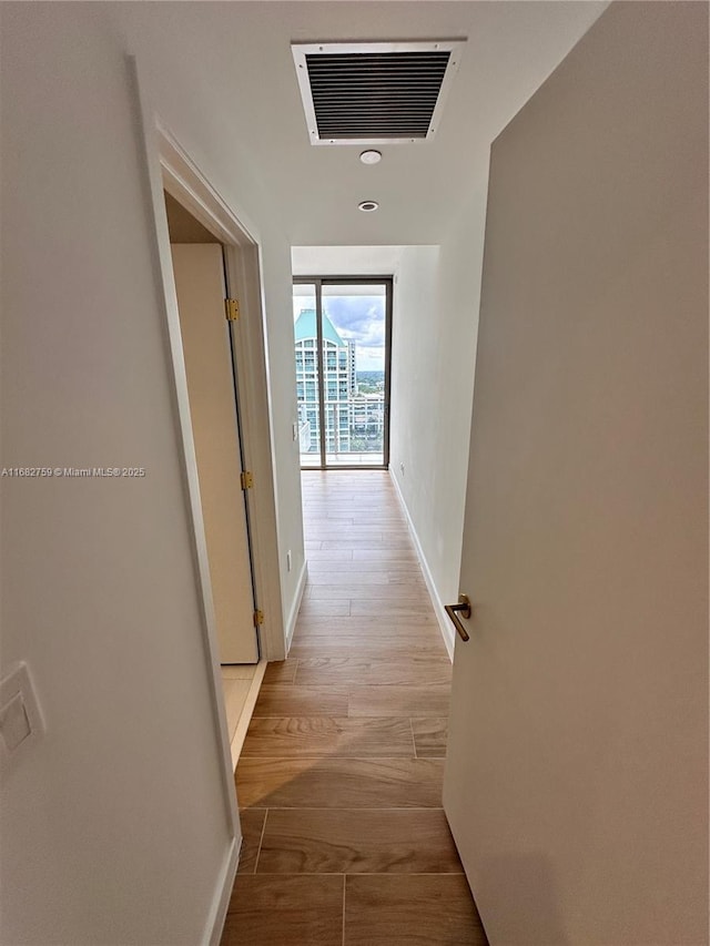 corridor featuring light hardwood / wood-style floors