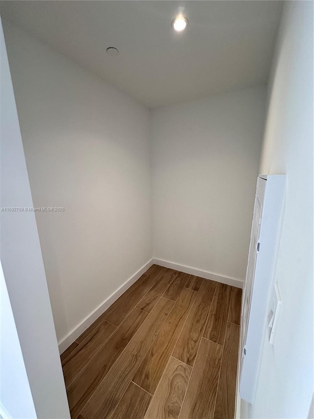 unfurnished room with wood-type flooring