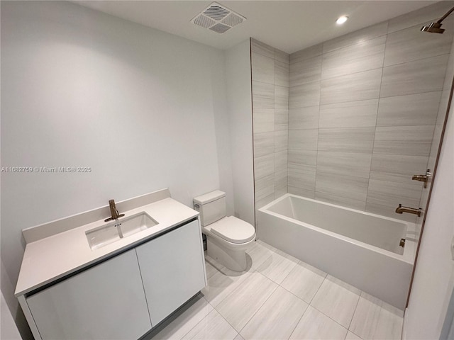 full bathroom with vanity, tiled shower / bath, and toilet