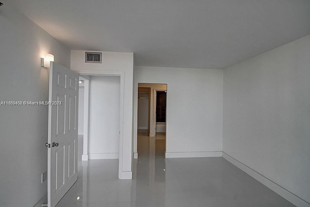 unfurnished room featuring concrete flooring