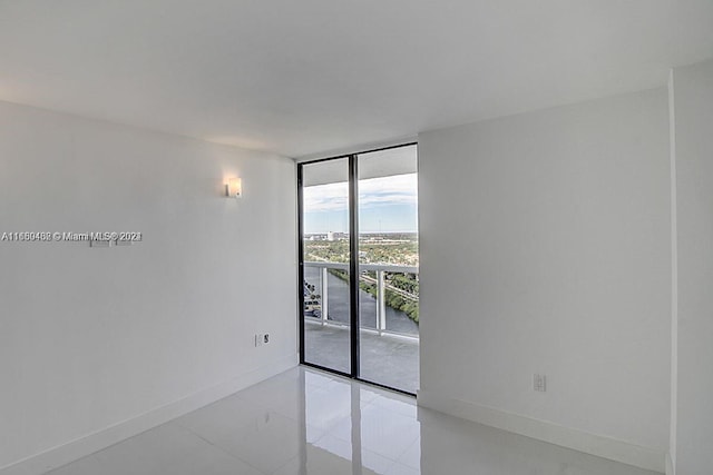 tiled spare room with floor to ceiling windows