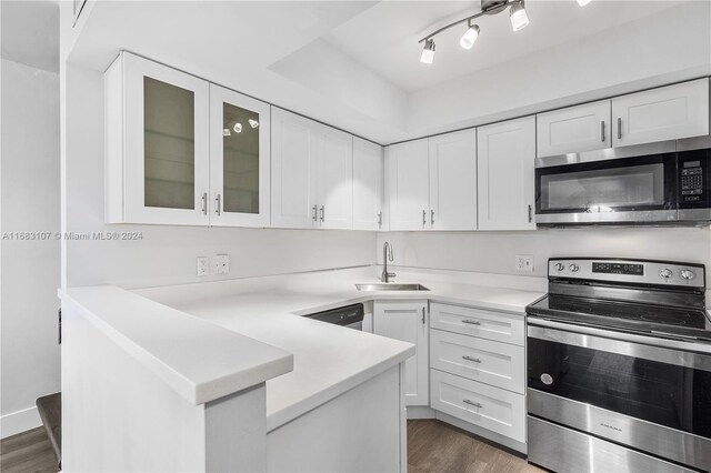 kitchen featuring sink, white cabinets, stainless steel appliances, and dark hardwood / wood-style floors