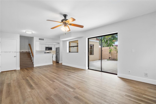 unfurnished living room with light hardwood / wood-style flooring and ceiling fan