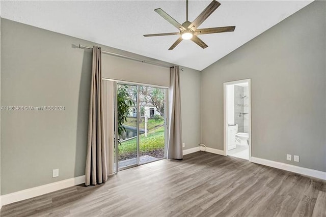 spare room with hardwood / wood-style floors, ceiling fan, and vaulted ceiling