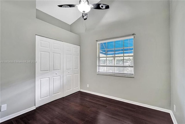 unfurnished bedroom featuring ceiling fan, a closet, and dark wood-type flooring