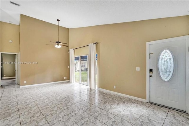 entrance foyer with vaulted ceiling, a wealth of natural light, and ceiling fan