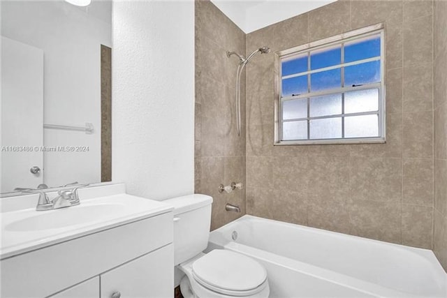 full bathroom with vanity, tiled shower / bath, and toilet