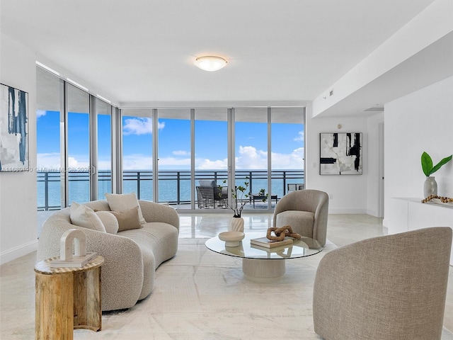 living room with expansive windows and a water view