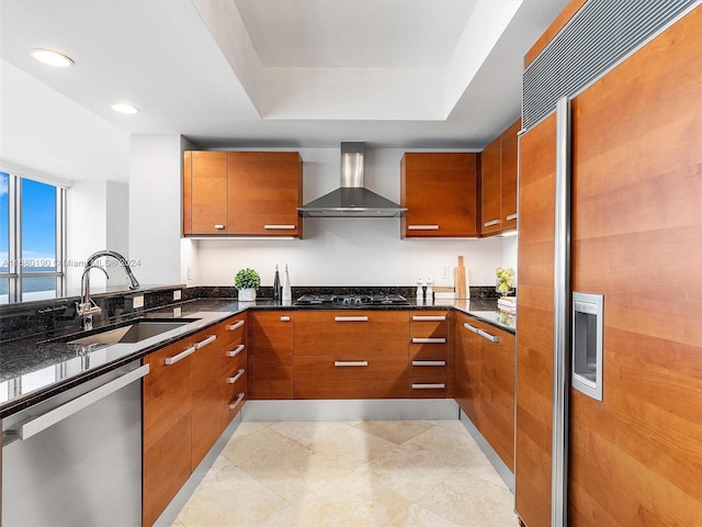 kitchen featuring sink, wall chimney exhaust hood, paneled built in fridge, stainless steel dishwasher, and a water view