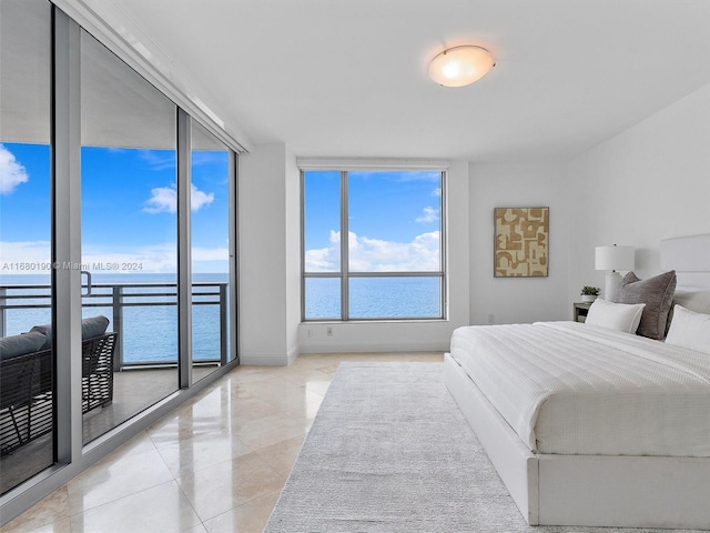 bedroom featuring a wall of windows, access to outside, light tile patterned flooring, and a water view