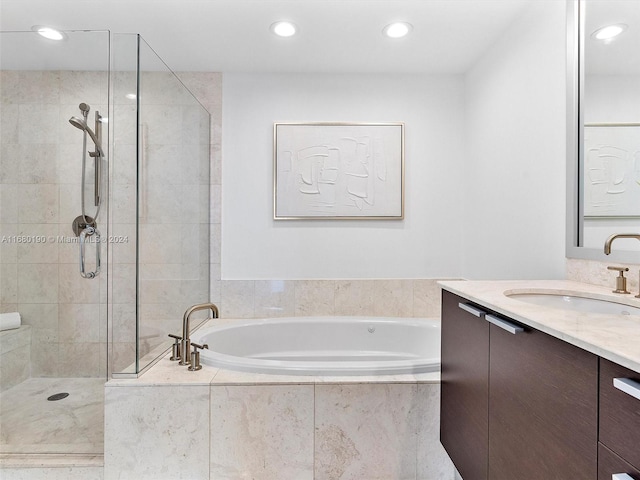 bathroom with vanity and separate shower and tub