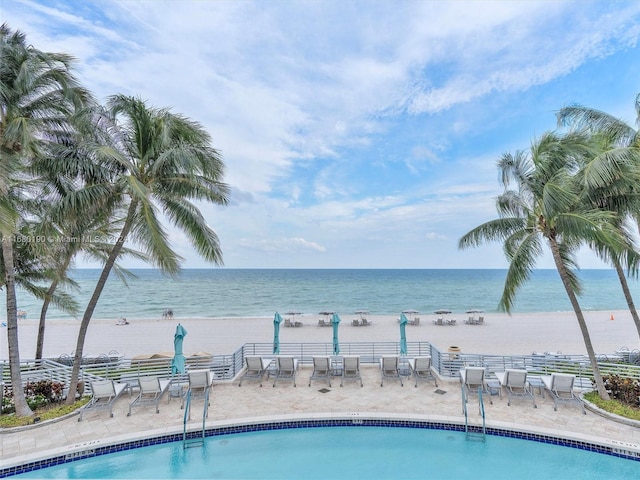 view of pool with a patio and a water view