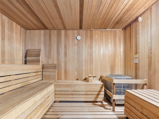 view of sauna with wood ceiling and wooden walls