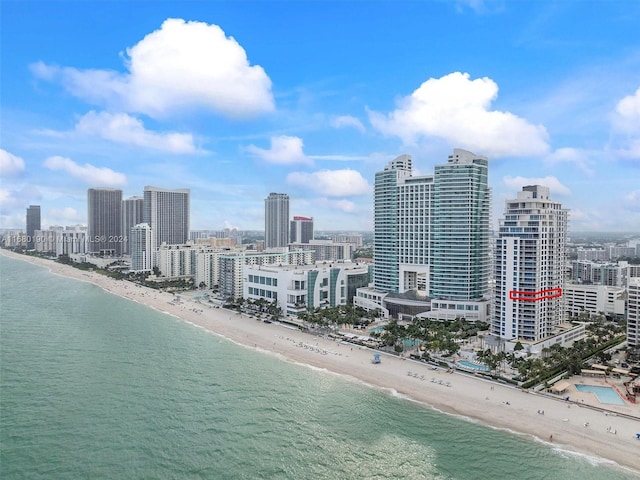 drone / aerial view featuring a water view and a beach view