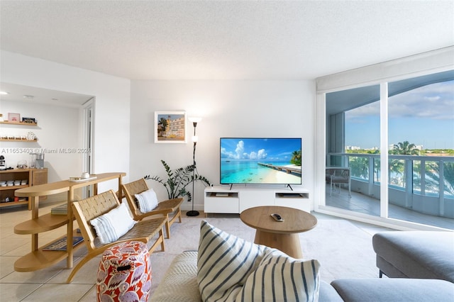 tiled living room featuring a textured ceiling