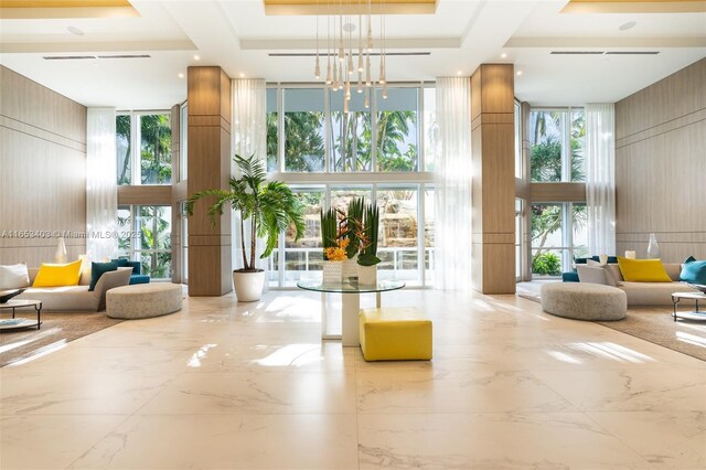 living room featuring tile patterned flooring, expansive windows, and a textured ceiling