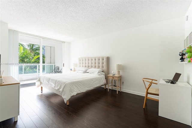 bedroom featuring a textured ceiling and dark wood-type flooring