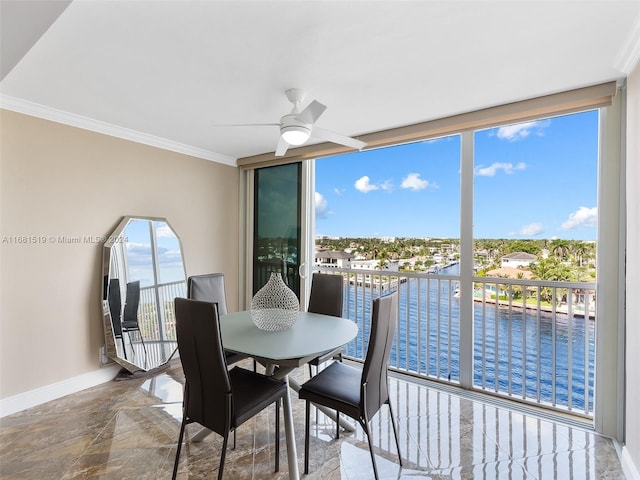 sunroom / solarium featuring a water view and ceiling fan