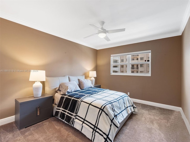 carpeted bedroom with ornamental molding and ceiling fan