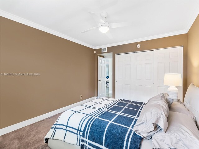 bedroom with a closet, ceiling fan, crown molding, and carpet