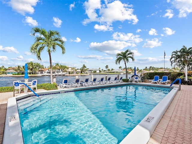 view of pool with a water view