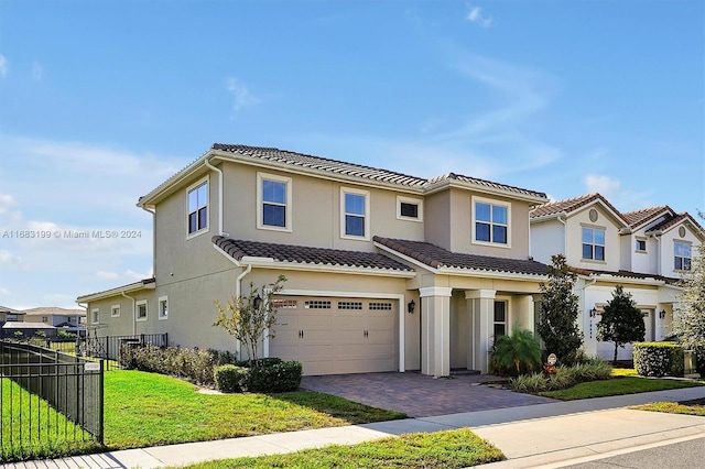 mediterranean / spanish-style house featuring a front lawn and a garage