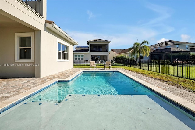 view of swimming pool featuring a patio and a lawn