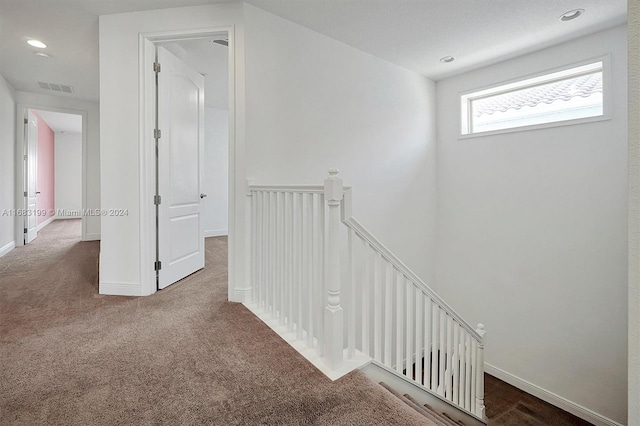 hallway featuring carpet