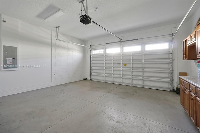 garage with a garage door opener and electric panel