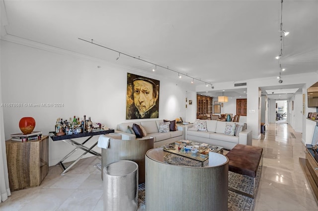 living room featuring ornamental molding and track lighting