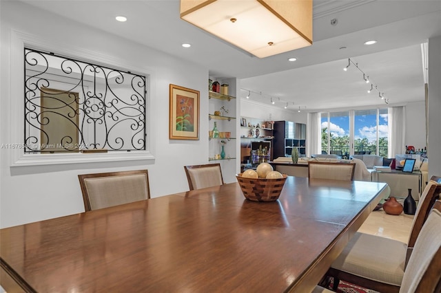 dining space featuring rail lighting