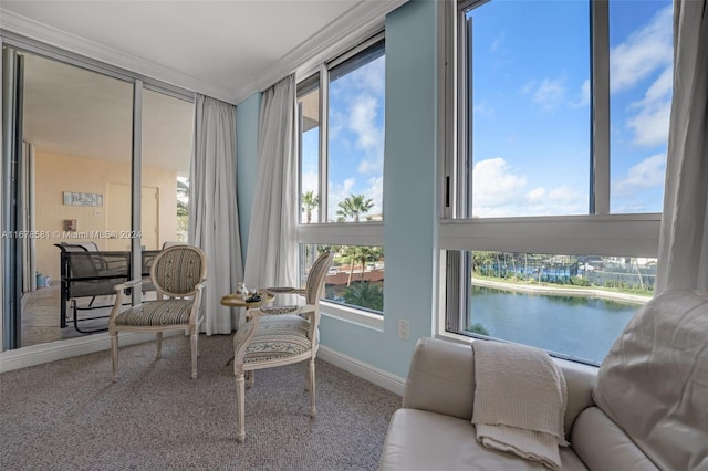 sunroom featuring a water view