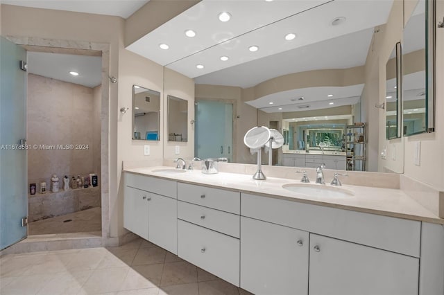 bathroom featuring vanity, tile patterned floors, and tiled shower