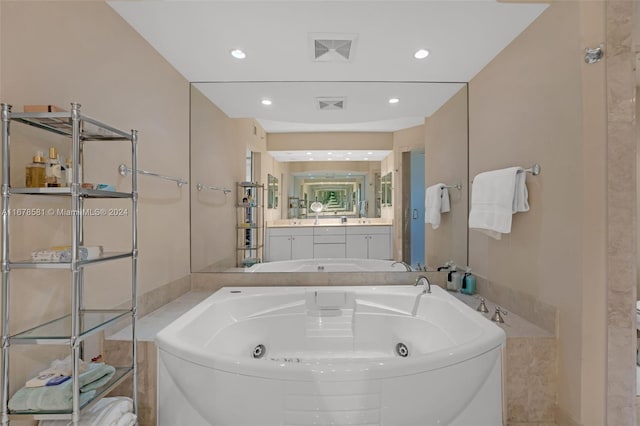 bathroom featuring vanity and a bath