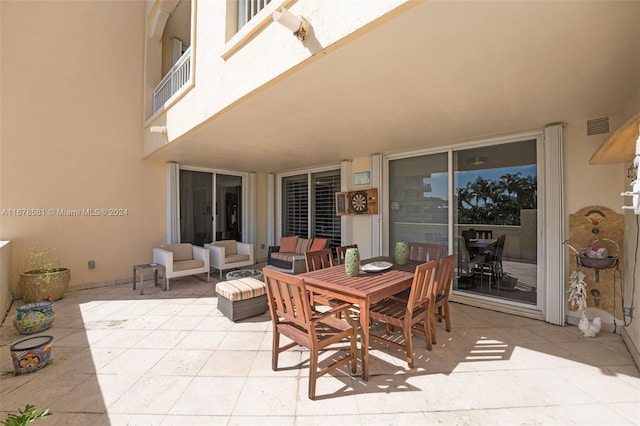 view of patio featuring a balcony