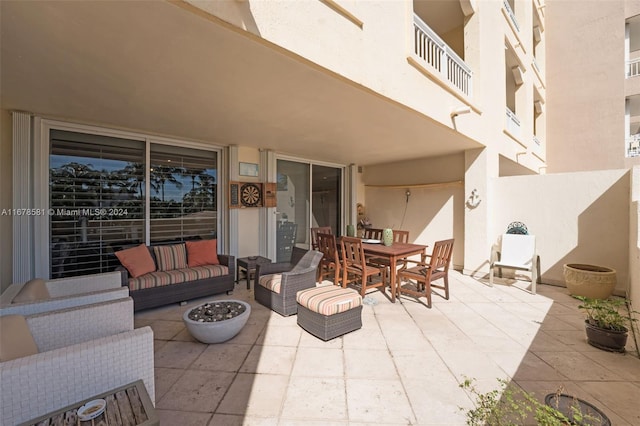 view of patio featuring an outdoor living space and a balcony