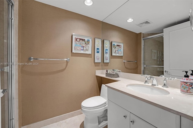 bathroom with toilet, an enclosed shower, vanity, and tile patterned floors