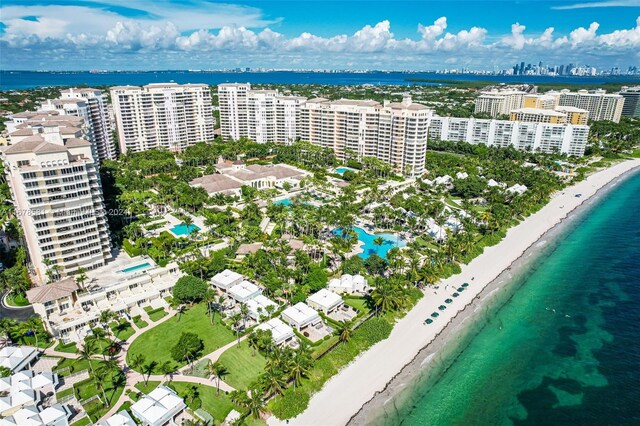 drone / aerial view featuring a water view and a beach view