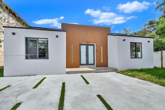 view of front facade featuring a patio area and french doors