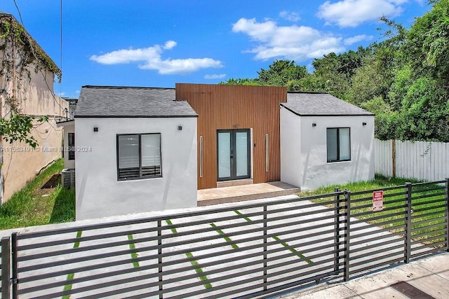 rear view of property featuring central air condition unit and french doors