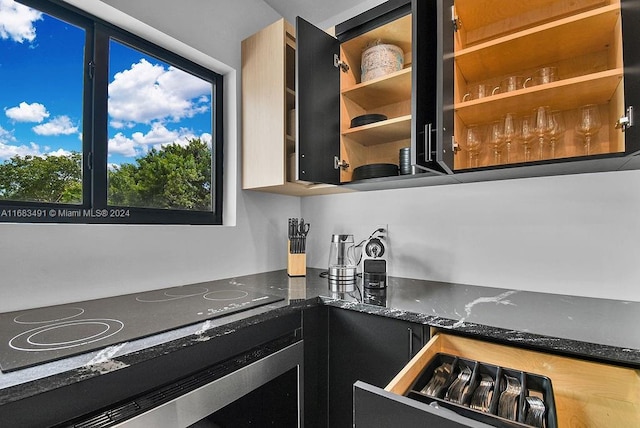 kitchen featuring black electric stovetop and stainless steel oven