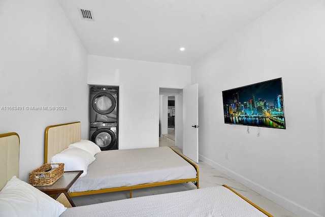 bedroom featuring stacked washing maching and dryer