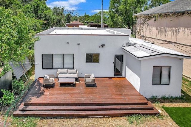 back of house featuring an outdoor living space and a wooden deck