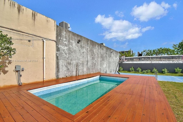 view of swimming pool featuring a deck