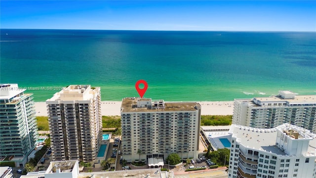 drone / aerial view featuring a water view and a view of the beach